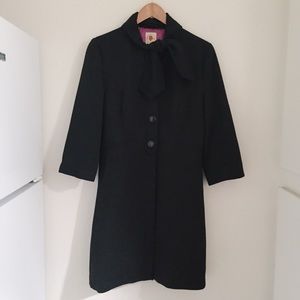 Long black coat with bow tie closure at neck